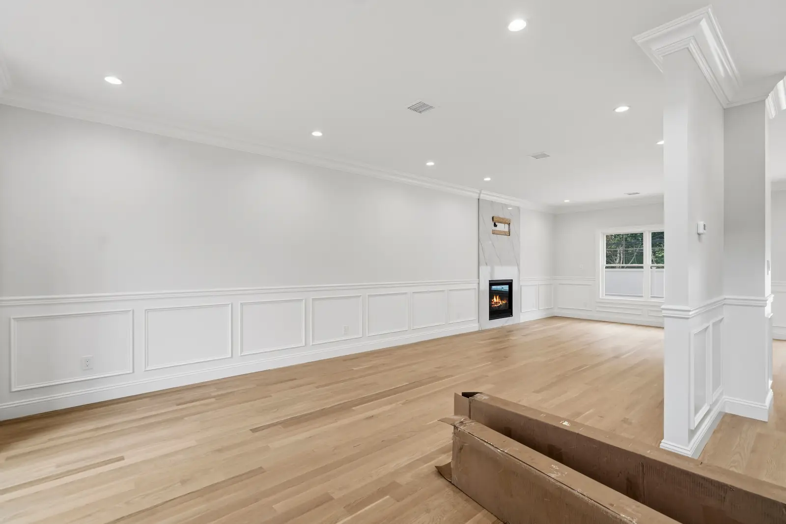 Syosset new construction — living room with fireplace