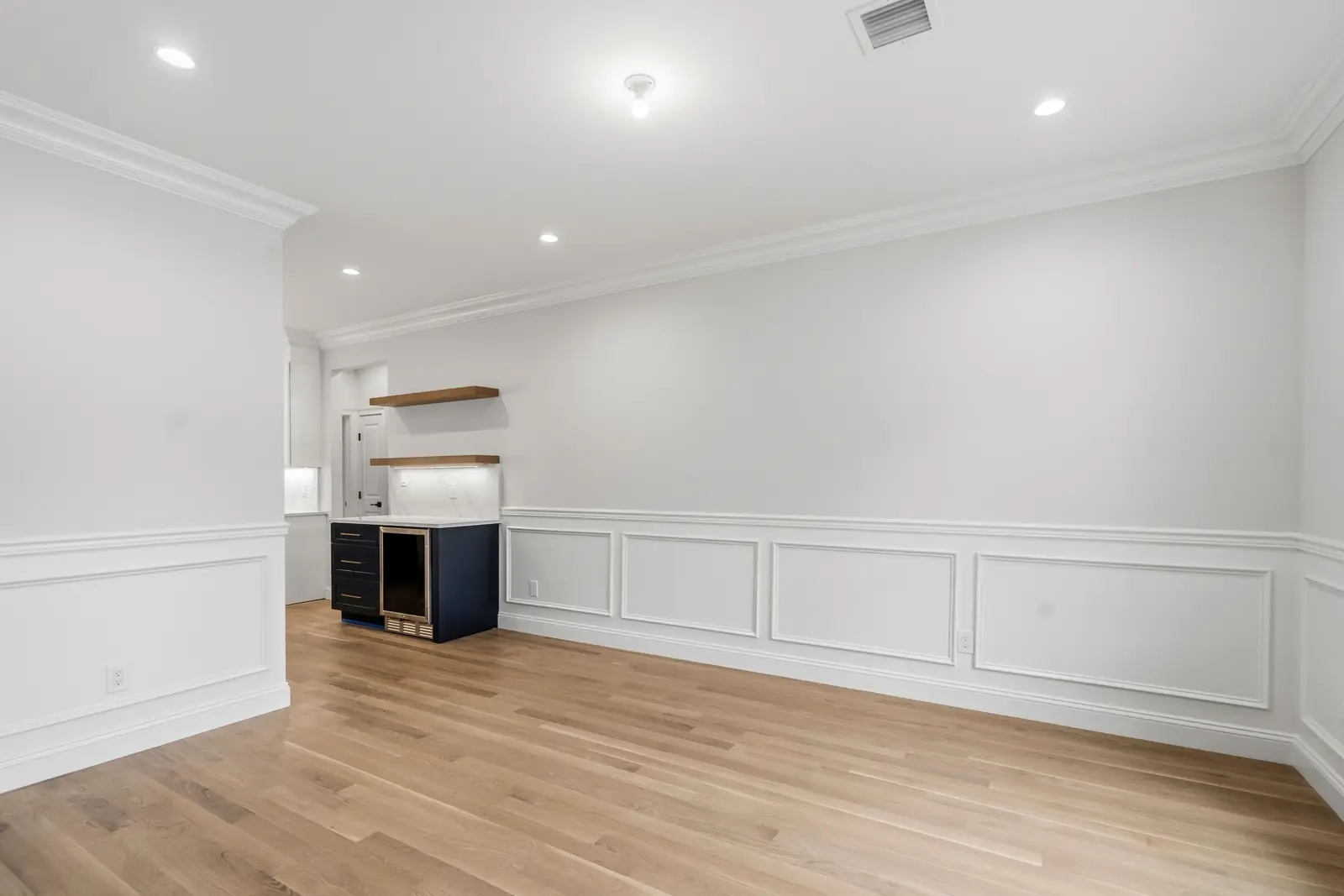 Syosset new construction — living room with wainscoting