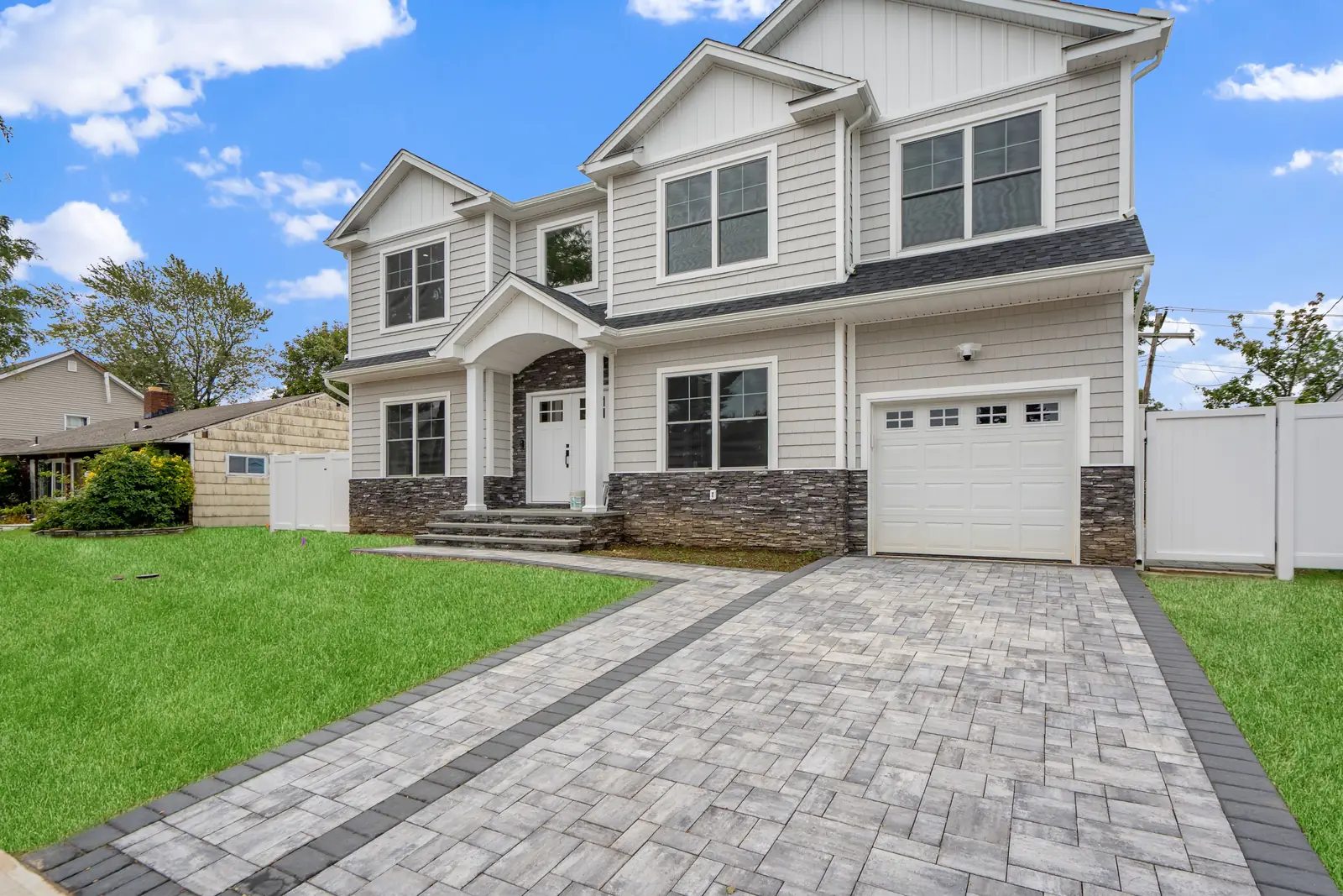 Syosset new construction — front exterior with paver driveway
