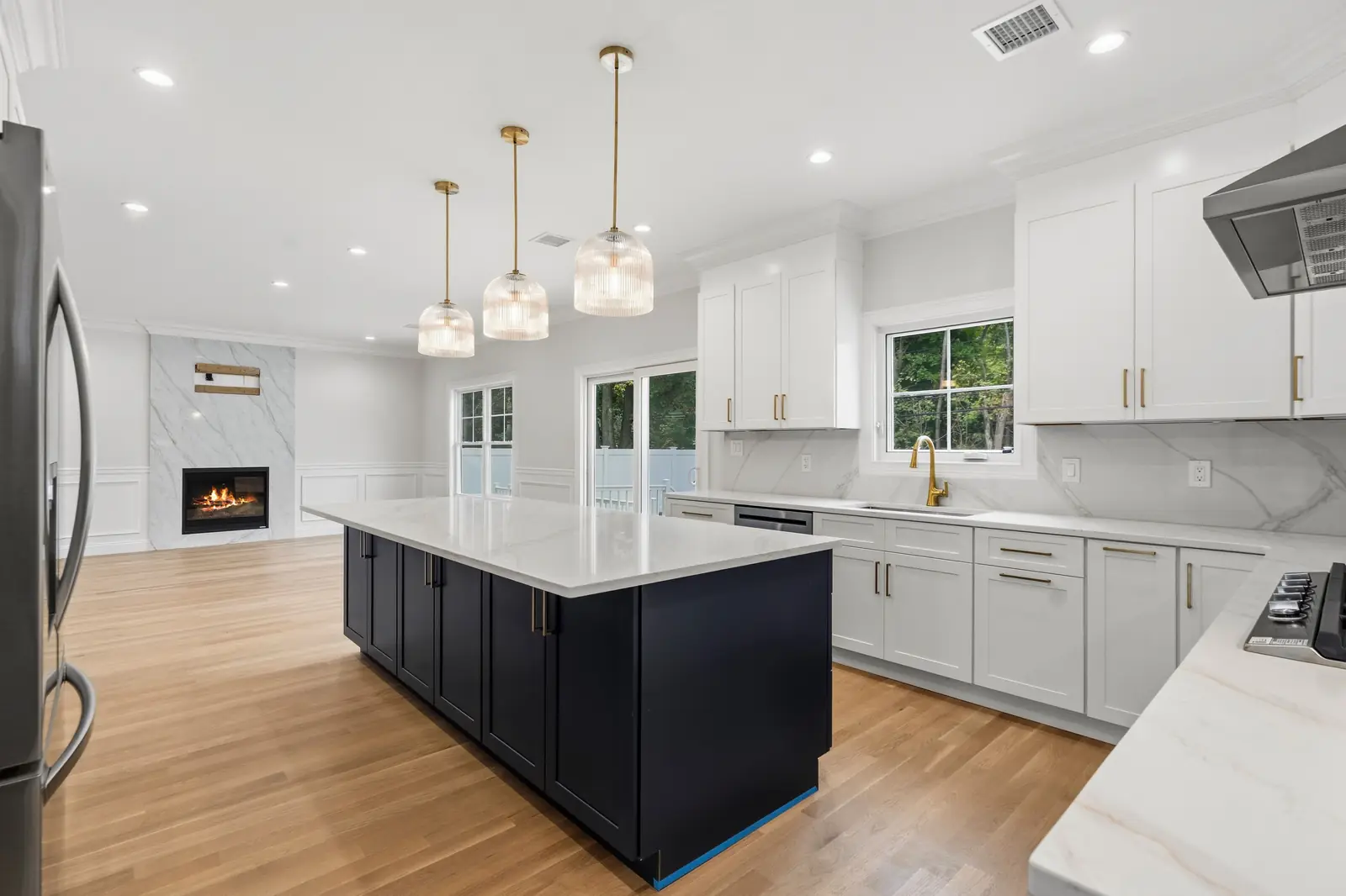 Syosset new construction — kitchen island and fireplace view